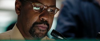 Movie still from “The Taking of Pelham 123” (2009), directed by Tony Scott – A person with a microphone; Close Up shot, Low angle