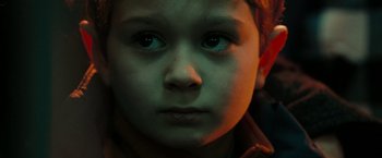 Movie still from “The Taking of Pelham 123” (2009), directed by Tony Scott – A child's face in a dark room; Close Up shot, High angle