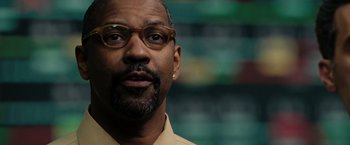 Movie still from “The Taking of Pelham 123” (2009), directed by Tony Scott – A person wearing glasses; Close Up shot, Over the shoulder angle