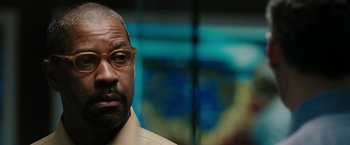 Movie still from “The Taking of Pelham 123” (2009), directed by Tony Scott – A person wearing glasses and a shirt; Close Up shot, Over the shoulder angle