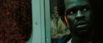 Movie still from “The Taking of Pelham 123” (2009), directed by Tony Scott – A man's face in front of a window; Close Up shot, High angle