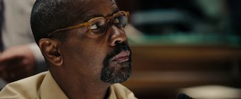 Movie still from “The Taking of Pelham 123” (2009), directed by Tony Scott – A person wearing glasses; Close Up shot, Low angle