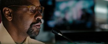 Movie still from “The Taking of Pelham 123” (2009), directed by Tony Scott – A person with a microphone; Close Up shot, Low angle