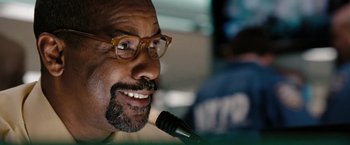 Movie still from “The Taking of Pelham 123” (2009), directed by Tony Scott – A person with a microphone; Close Up shot, Low angle