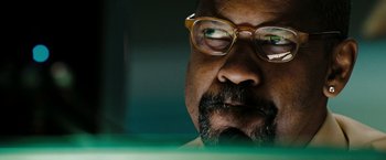 Movie still from “The Taking of Pelham 123” (2009), directed by Tony Scott – A person wearing glasses; Close Up shot, Low angle