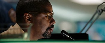 Movie still from “The Taking of Pelham 123” (2009), directed by Tony Scott – A person with a microphone; Close Up shot, Low angle