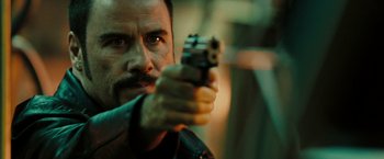 Movie still from “The Taking of Pelham 123” (2009), directed by Tony Scott – A person holding a gun; Close Up shot, Over the shoulder angle