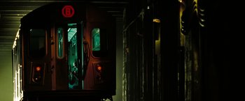 Movie still from “The Taking of Pelham 123” (2009), directed by Tony Scott – A subway train is seen through a window; Wide shot, Low angle