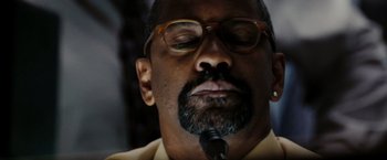 Movie still from “The Taking of Pelham 123” (2009), directed by Tony Scott – A person with a microphone; Close Up shot, Low angle