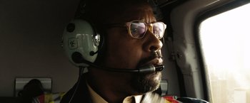 Movie still from “The Taking of Pelham 123” (2009), directed by Tony Scott – A person in a helicopter wearing a headset; Close Up shot, Low angle