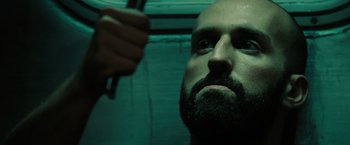 Movie still from “The Taking of Pelham 123” (2009), directed by Tony Scott – A man with a goatee and a beard combing his hair; Close Up shot, Low angle