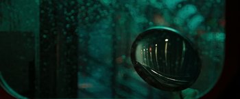 Movie still from “The Taking of Pelham 123” (2009), directed by Tony Scott – A rear view mirror of a car reflecting a forest; Extreme Close Up shot, High angle