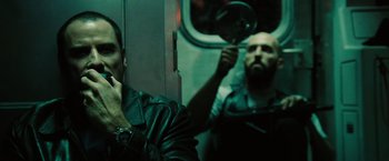 Movie still from “The Taking of Pelham 123” (2009), directed by Tony Scott – Two men on a train looking in the same direction; Close Up shot, Over the shoulder angle