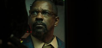 Movie still from “The Taking of Pelham 123” (2009), directed by Tony Scott – A person wearing a suit and glasses; Close Up shot, Low angle