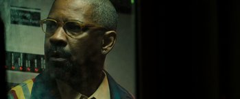 Movie still from “The Taking of Pelham 123” (2009), directed by Tony Scott – A person wearing glasses and a jacket; Close Up shot, Low angle