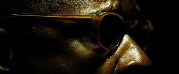 Movie still from “The Taking of Pelham 123” (2009), directed by Tony Scott – A pair of glasses on a person; Extreme Close Up shot, Low angle