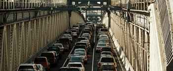 Movie still from “The Taking of Pelham 123” (2009), directed by Tony Scott – A man walking down a street with a lot of cars; Extreme Wide shot, High angle