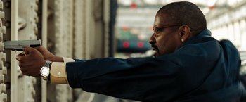 Movie still from “The Taking of Pelham 123” (2009), directed by Tony Scott – A man with glasses is pointing at something in the distance; Close Up shot, Low angle