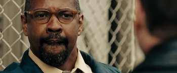 Movie still from “The Taking of Pelham 123” (2009), directed by Tony Scott – A person wearing glasses and a beard; Close Up shot, Over the shoulder angle