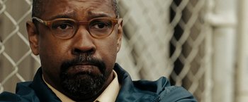 Movie still from “The Taking of Pelham 123” (2009), directed by Tony Scott – A person wearing glasses; Close Up shot, Over the shoulder angle