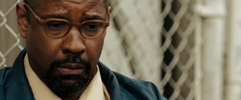 Movie still from “The Taking of Pelham 123” (2009), directed by Tony Scott – A person wearing glasses; Close Up shot, Over the shoulder angle