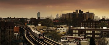 Movie still from “The Taking of Pelham 123” (2009), directed by Tony Scott – A train traveling down the tracks in a city; Extreme Wide shot, High angle