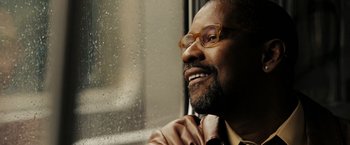 Movie still from “The Taking of Pelham 123” (2009), directed by Tony Scott – A person wearing a suit and tie; Close Up shot, Low angle