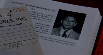 Movie still from “The Talented Mr. Ripley” (1999), directed by Anthony Minghella – A page from a book with an image of richard greenleaf; Extreme Close Up shot, Overhead angle