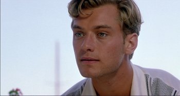 Movie still from “The Talented Mr. Ripley” (1999), directed by Anthony Minghella – A person wearing a white shirt; Close Up shot, Over the shoulder angle
