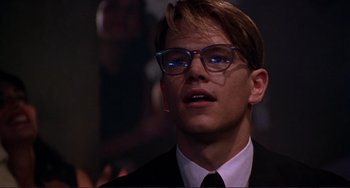 Movie still from “The Talented Mr. Ripley” (1999), directed by Anthony Minghella – A man in a suit and glasses looking up; Close Up shot, Low angle
