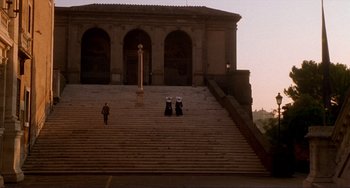 Movie still from “The Talented Mr. Ripley” (1999), directed by Anthony Minghella – A couple of people that are standing on some steps; Extreme Wide shot, Low angle