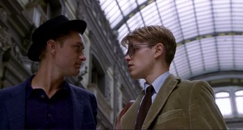 Movie still from “The Talented Mr. Ripley” (1999), directed by Anthony Minghella – Two young men in suits and ties talking to each other; Close Up shot, Low angle