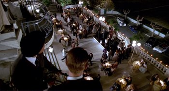Movie still from “The Talented Mr. Ripley” (1999), directed by Anthony Minghella – A group of people standing around a building at night; Extreme Wide shot, High angle
