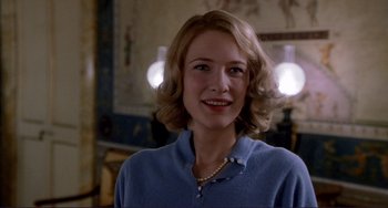 Movie still from “The Talented Mr. Ripley” (1999), directed by Anthony Minghella – A woman with blonde hair wearing a blue sweater; Close Up shot, Over the shoulder angle