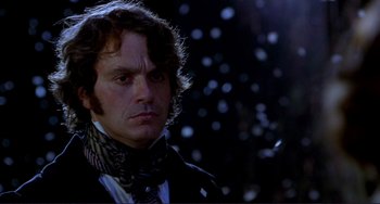 Movie still from “The Talented Mr. Ripley” (1999), directed by Anthony Minghella – A person wearing a suit and tie; Close Up shot, Low angle