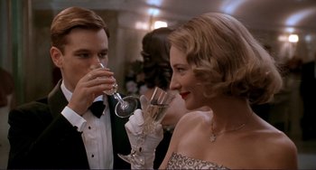 Movie still from “The Talented Mr. Ripley” (1999), directed by Anthony Minghella – A man and a woman drinking wine at a party; Close Up shot, Low angle