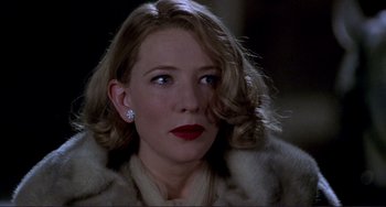 Movie still from “The Talented Mr. Ripley” (1999), directed by Anthony Minghella – A woman with red lipstick wearing a fur coat; Close Up shot, Over the shoulder angle
