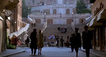 Movie still from “The Talented Mr. Ripley” (1999), directed by Anthony Minghella – A group of people standing on a set of stairs; Extreme Wide shot, High angle