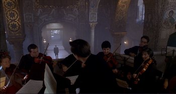 Movie still from “The Talented Mr. Ripley” (1999), directed by Anthony Minghella – A group of people playing musical instruments inside a building; Extreme Wide shot, Low angle