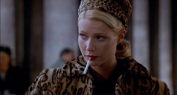 Movie still from “The Talented Mr. Ripley” (1999), directed by Anthony Minghella – A woman in a leopard print coat smoking a cigarette; Close Up shot, Over the shoulder angle