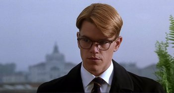 Movie still from “The Talented Mr. Ripley” (1999), directed by Anthony Minghella – A man in a suit and tie wearing glasses; Close Up shot, Low angle