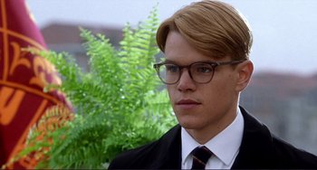 Movie still from “The Talented Mr. Ripley” (1999), directed by Anthony Minghella – A man in a suit and tie with glasses; Close Up shot, Low angle