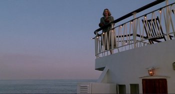 Movie still from “The Talented Mr. Ripley” (1999), directed by Anthony Minghella – A woman standing on a balcony of an ocean liner at dusk; Wide shot, Low angle