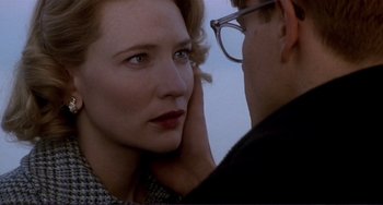 Movie still from “The Talented Mr. Ripley” (1999), directed by Anthony Minghella – A man touching the ear of a beautiful woman; Close Up shot, Over the shoulder angle