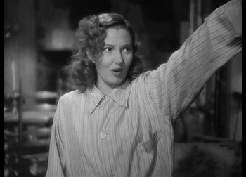 Movie still from “The Talk of the Town” (1942), directed by George Stevens – A black and white photo of a woman waving; Medium shot, Low angle