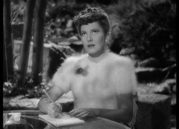 Movie still from “The Talk of the Town” (1942), directed by George Stevens – An old photo of a woman writing in a notebook; Medium shot, High angle