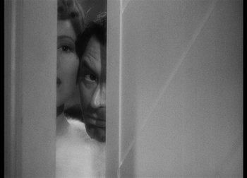 Movie still from “The Talk of the Town” (1942), directed by George Stevens – A man and a woman looking into a mirror; Close Up shot, Overhead angle