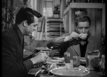 Movie still from “The Talk of the Town” (1942), directed by George Stevens – Two men are sitting at a table drinking coffee; Medium shot, High angle