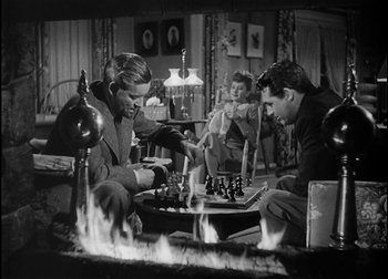 Movie still from “The Talk of the Town” (1942), directed by George Stevens – Two men playing chess in front of a fireplace; Medium shot, High angle