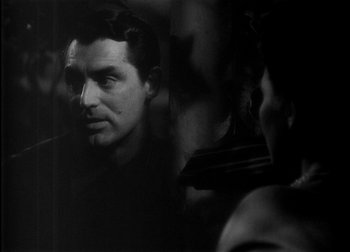 Movie still from “The Talk of the Town” (1942), directed by George Stevens – A black - and - white photo of a man and a woman; Close Up shot, Over the shoulder angle